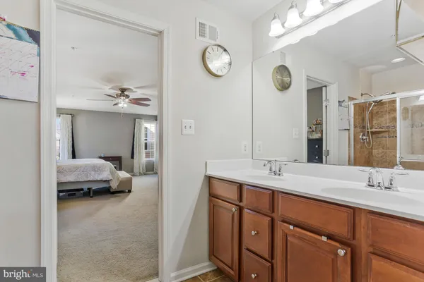a bathroom with a sink toilet vanity and shower