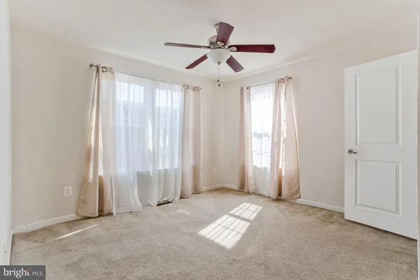 a view of a house with a wooden wall roof deck