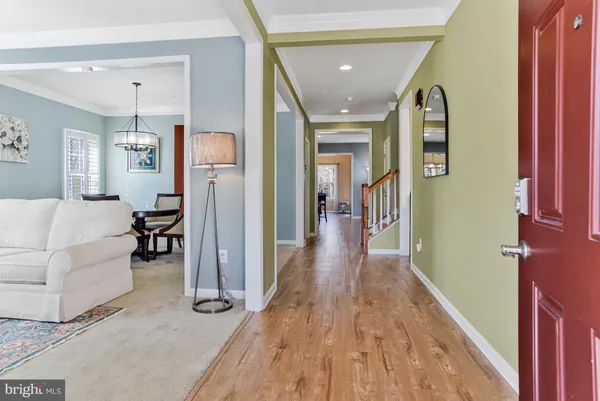 a bedroom with a bed and a couch next to a window
