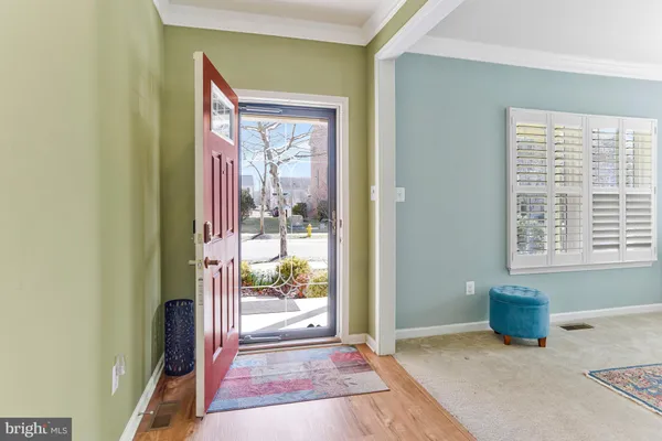 a dining room with furniture window and wooden floor