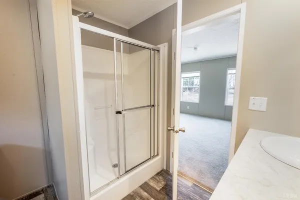 a view of a bathroom with a glass door shower