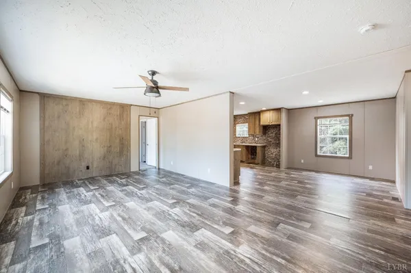 a view of empty room with wooden floor and window