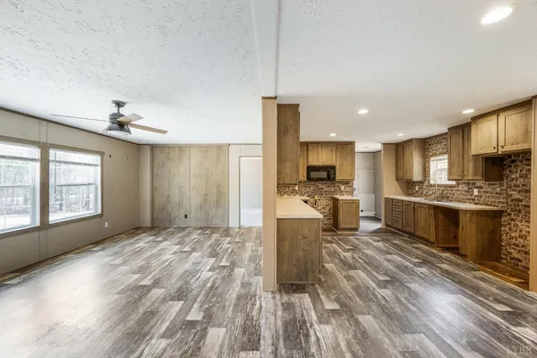 a view of kitchen with sink microwave and refrigerator
