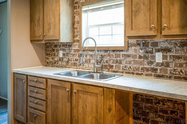 a kitchen with granite countertop a sink and a window