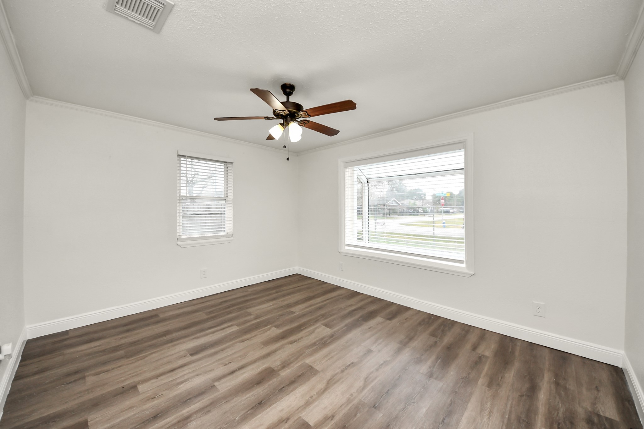 1139 Hartwick Road Houston, TX 77037 - Photo 14 of 38 a view of a big room with wooden floor and windows