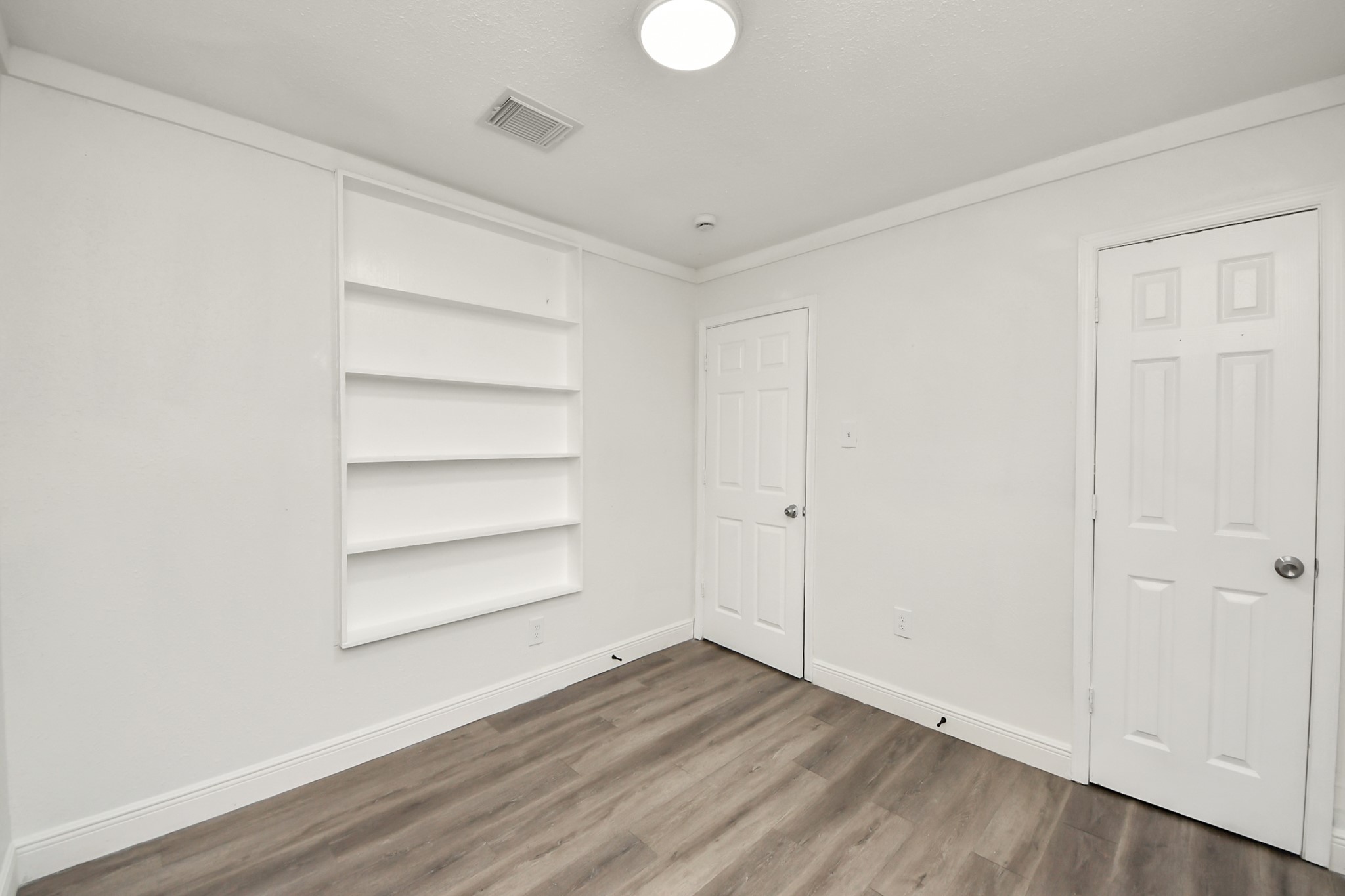 1139 Hartwick Road Houston, TX 77037 - Photo 27 of 38 a view of a room with wooden floor and white walls