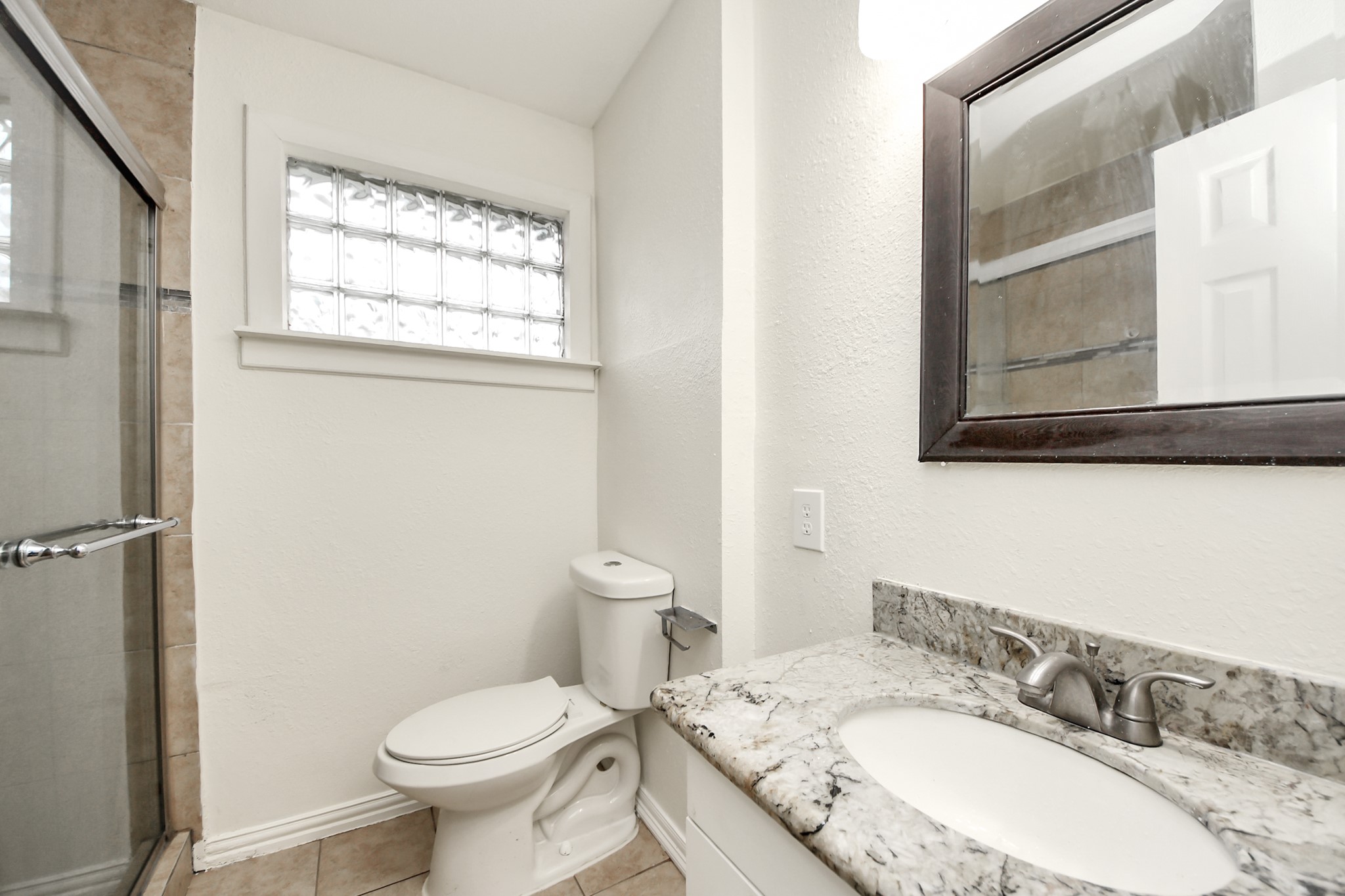 1139 Hartwick Road Houston, TX 77037 - Photo 28 of 38 a bathroom with a granite countertop sink toilet and a mirror