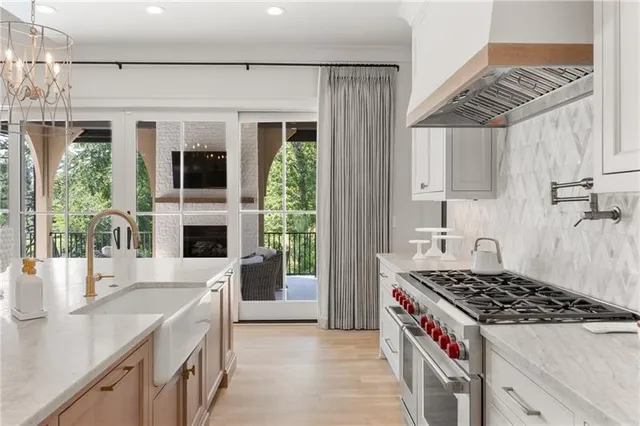 a kitchen with granite countertop a sink and a refrigerator