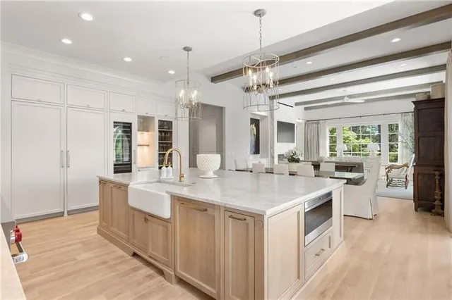 a spacious bedroom with a bed and a chandelier