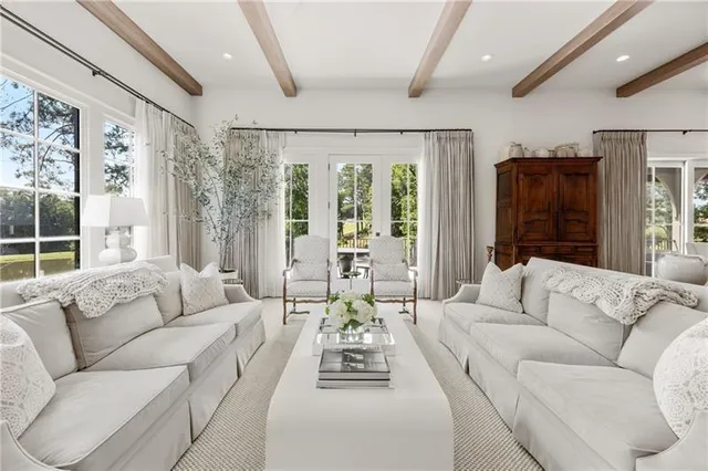 a living room with furniture and kitchen view