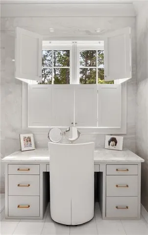 a living room with furniture and large windows