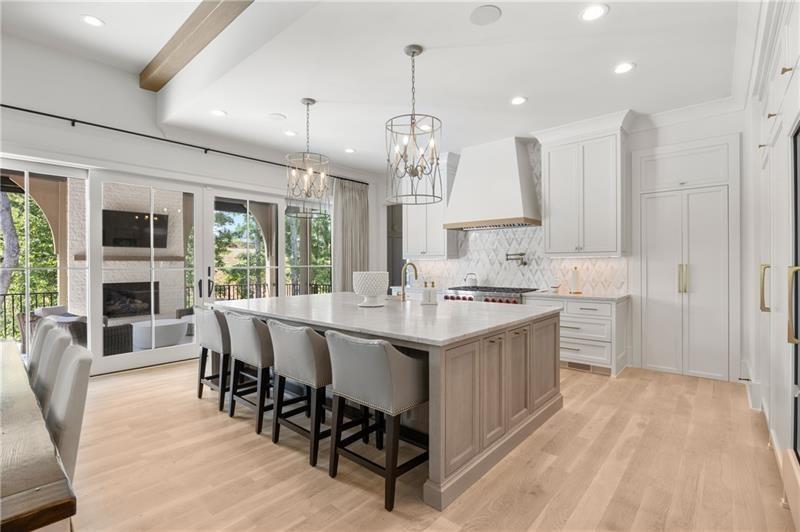 3940 Cottage Park Alpharetta, GA 30004 - Photo 4 of 76 a kitchen with kitchen island granite countertop a sink cabinets and wooden floor