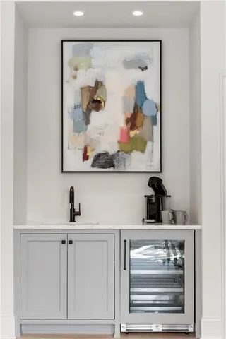 a view of a swimming pool with potted plants and large trees