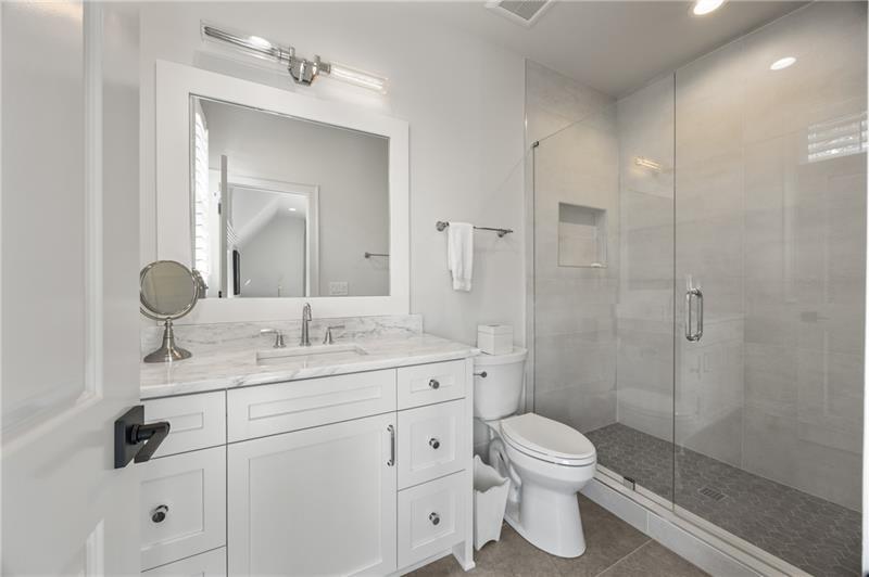 3940 Cottage Park Alpharetta, GA 30004 - Photo 50 of 76 a bathroom with a toilet a sink a glass door a shower a mirror and vanity