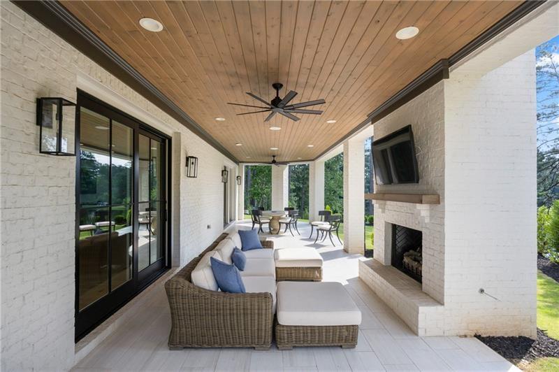 3940 Cottage Park Alpharetta, GA 30004 - Photo 68 of 76 a living room with furniture a fireplace and a flat screen tv