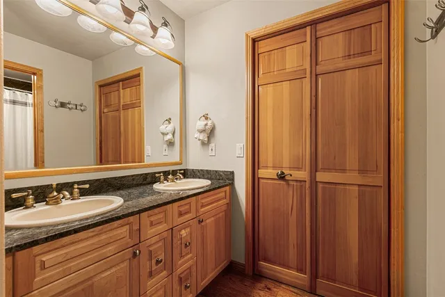 a bedroom with a bed and a lamp on dresser