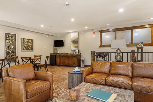 a living room with fireplace furniture and a large window