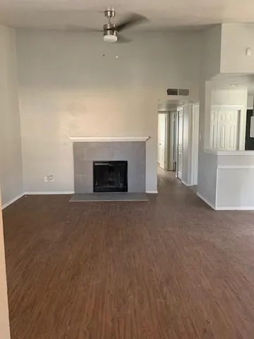 an empty room with fireplace and windows