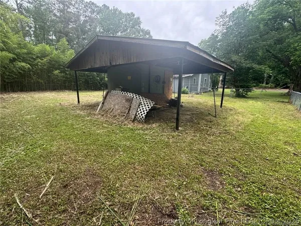 a backyard of a house with shaded area