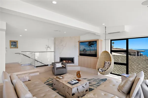 a living room with furniture a flat screen tv and a table