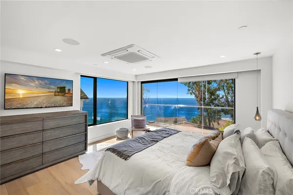 a bedroom with a large bed and a large window