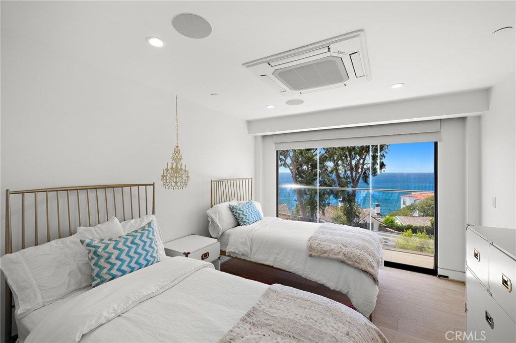 2629 Victoria Drive Laguna Beach, CA 92651 - Photo 21 of 35 a bedroom with a large bed and a large window
