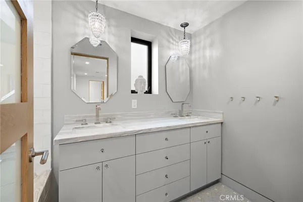 a bathroom with a double vanity sink and a mirror