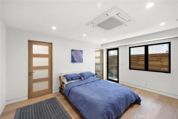 a bedroom with a bed and a large window