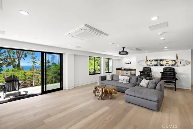 a living room with furniture and large windows