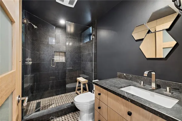 a bathroom with a sink toilet and shower