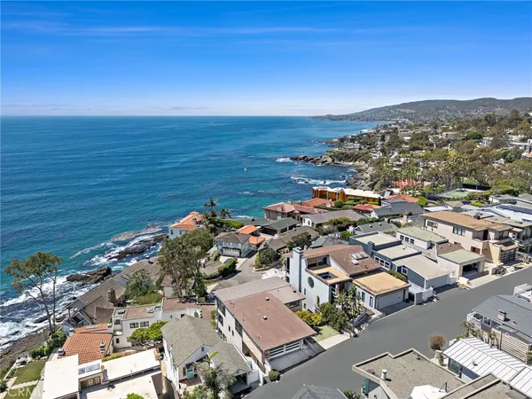 an aerial view of a city with ocean view