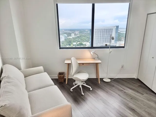 a view of a room that has a couch and a table in it
