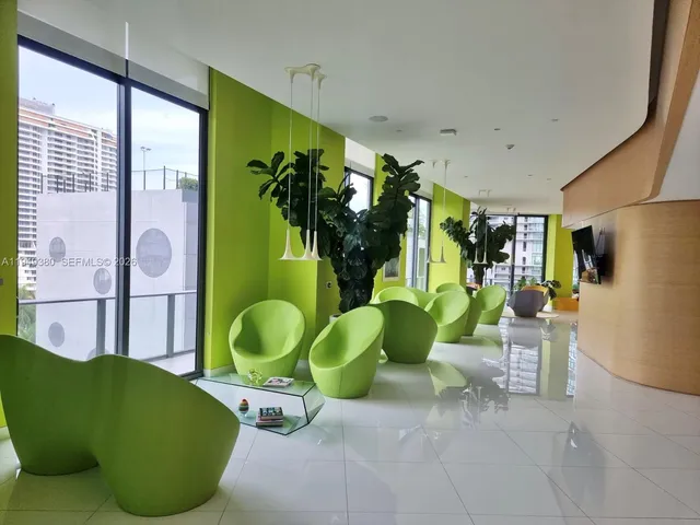 a living room filled with furniture and a large window