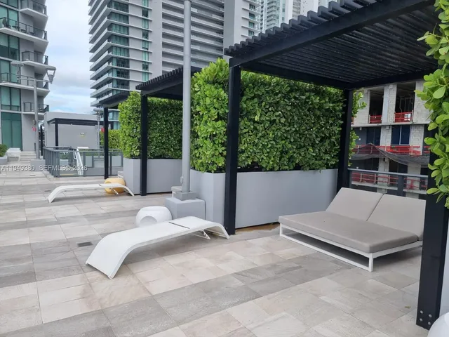 a view of patio with a table and chairs under an umbrella