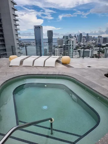 a terrace with outdoor seating and city view