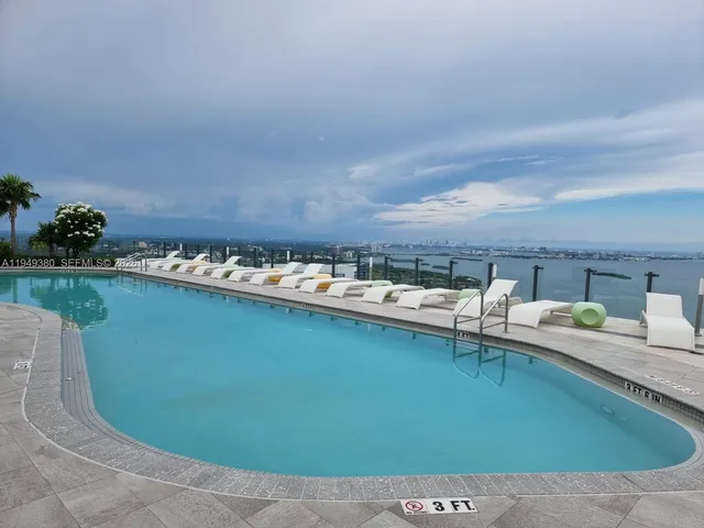 a view of a swimming pool and lounge chair