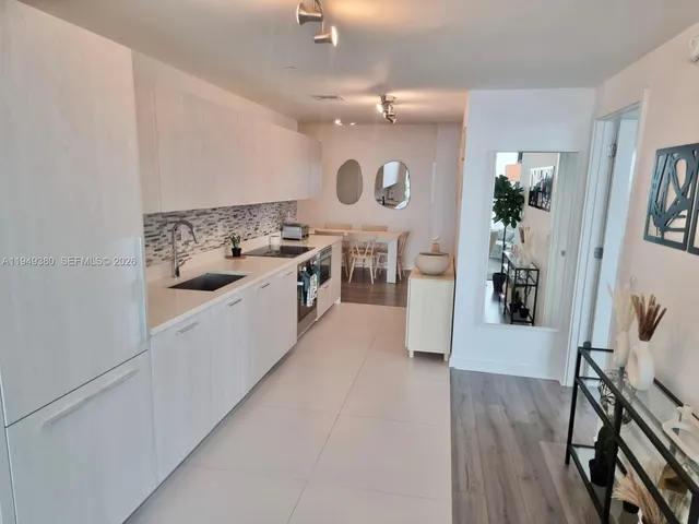 a kitchen with a sink appliances and cabinets