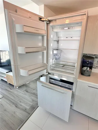 a kitchen with a refrigerator and a stove