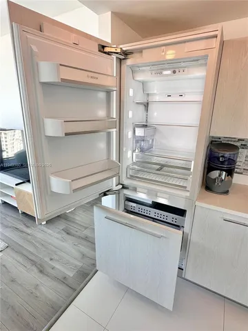 a kitchen with a refrigerator and a stove