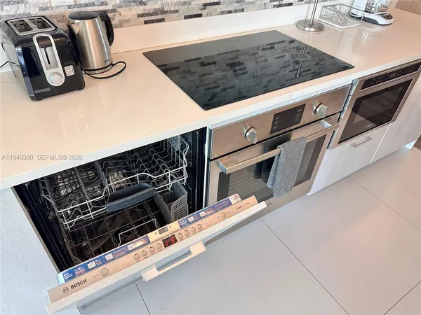 a close view of a stove a microwave and a counter space