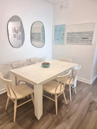 a dining room with wooden floor and a table