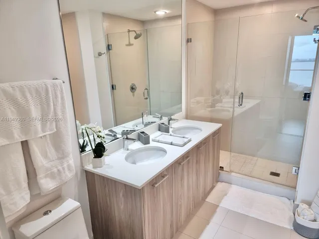 a bathroom with a sink a mirror and a shower