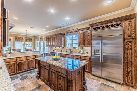 a kitchen with a stove and a wooden cabinets