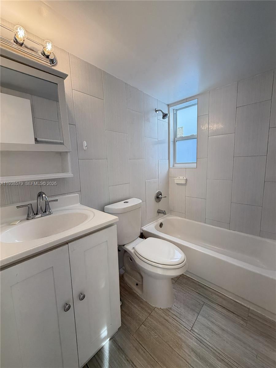 a bathroom with a toilet a sink and bathtub