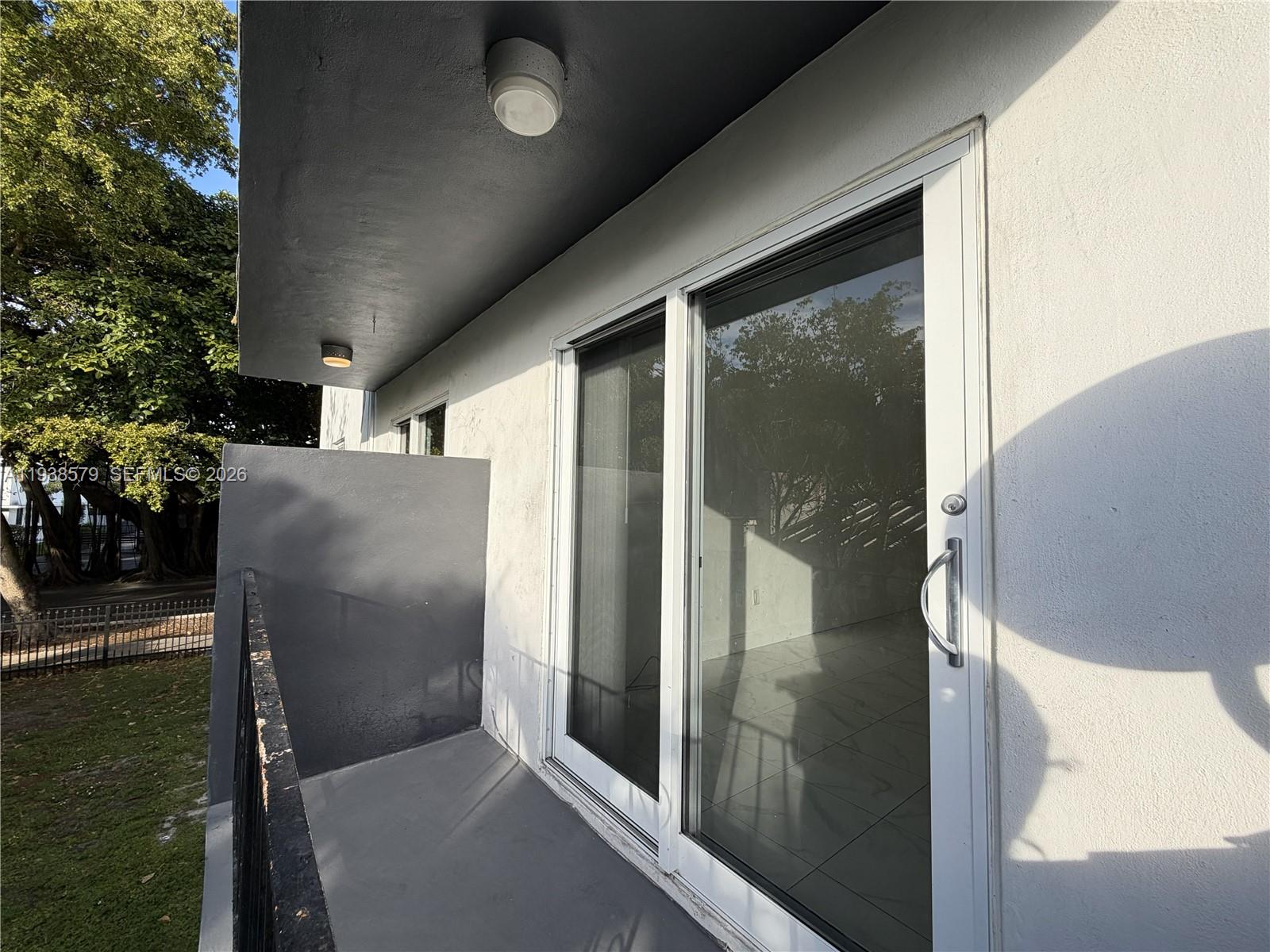 1860 Southwest 22nd Street, Unit 8 Miami, FL 33145 - Photo 3 of 10 a view of a glass door of the house