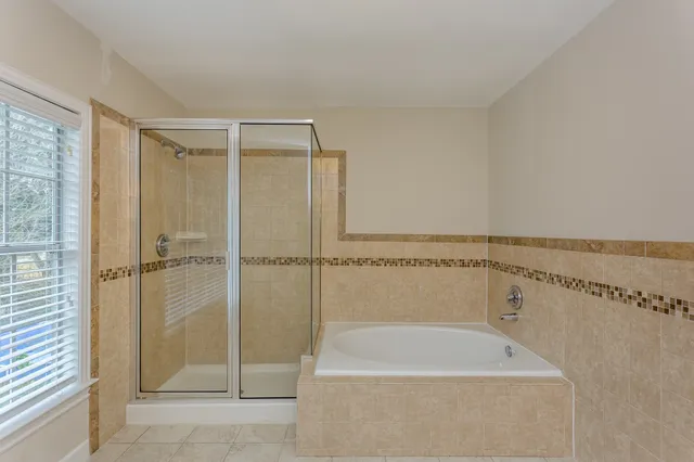 a kitchen with granite countertop cabinets stainless steel appliances a sink and a window