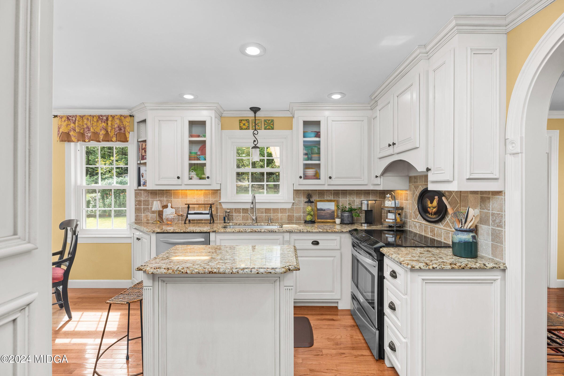 552 Plantation Road Gray, GA 31032 - Photo 13 of 38 a kitchen with granite countertop a sink stove top oven and cabinets