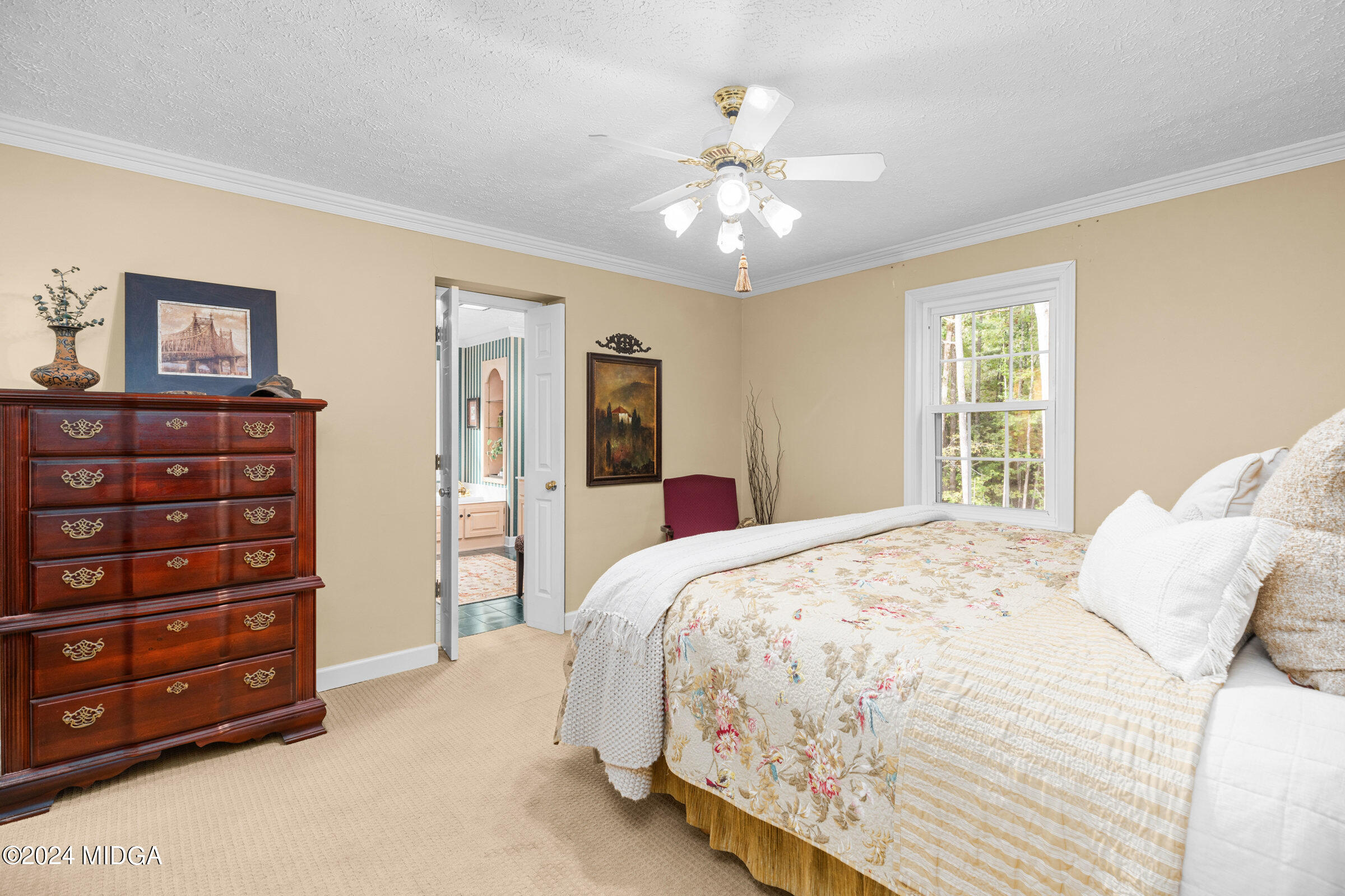 552 Plantation Road Gray, GA 31032 - Photo 21 of 38 a bedroom with a bed and a chandelier