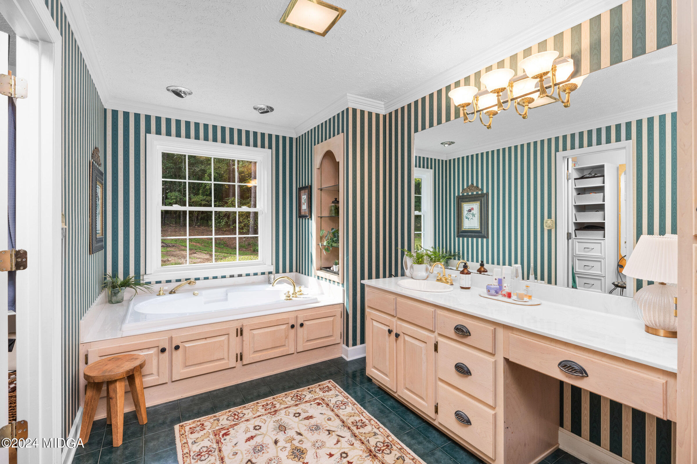 552 Plantation Road Gray, GA 31032 - Photo 23 of 38 a bathroom with a double vanity sink a mirror and a bathtub