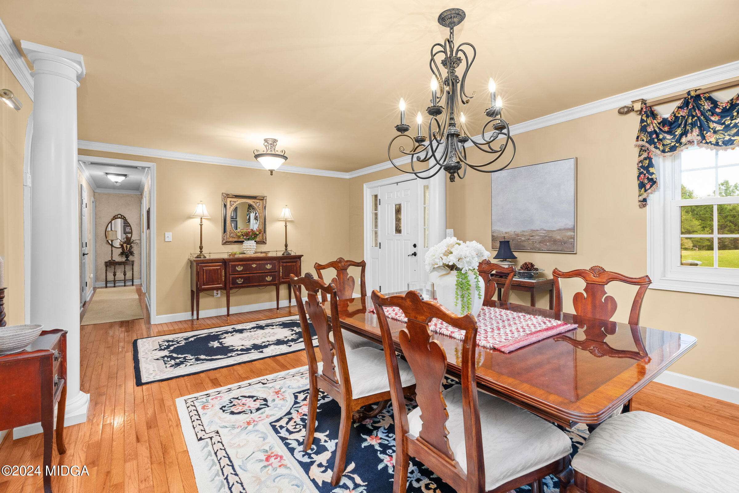 552 Plantation Road Gray, GA 31032 - Photo 4 of 38 a living room with dining table and a chandelier